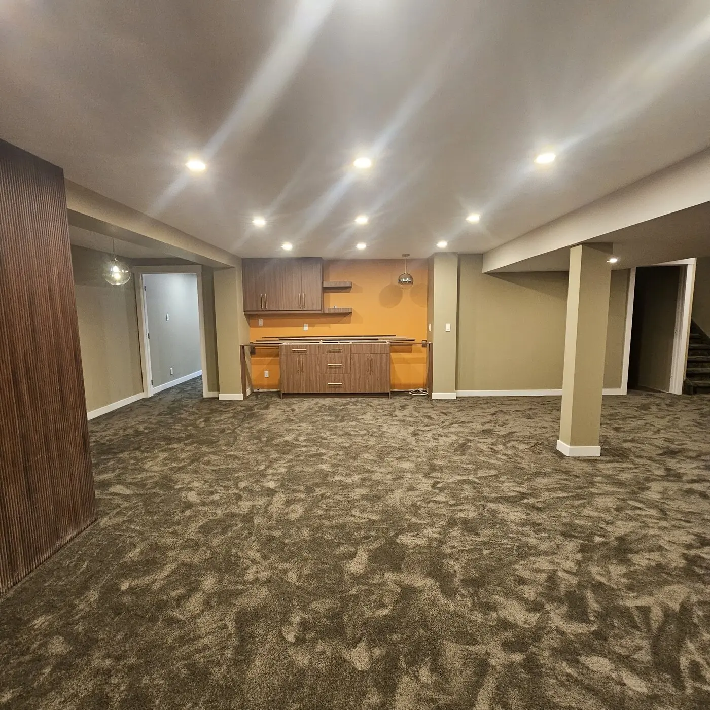 Completed basement development with recessed lighting