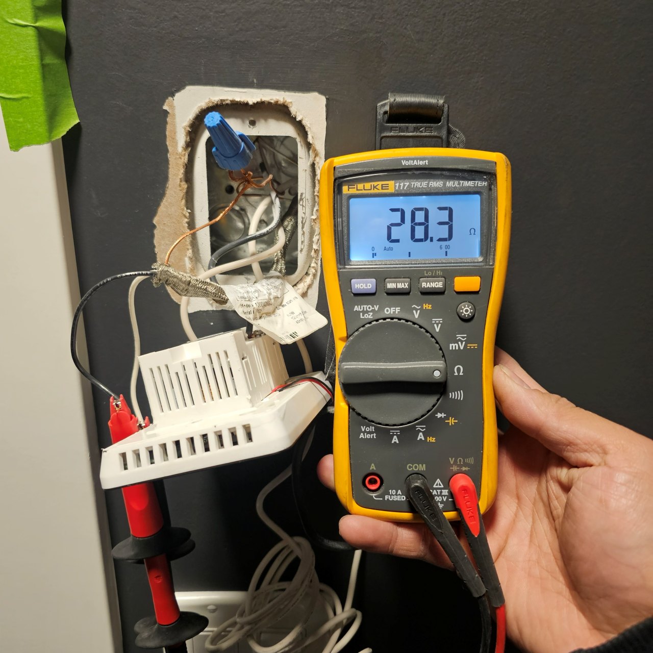 Fluke multimeter connected to control wiring during diagnostic checks