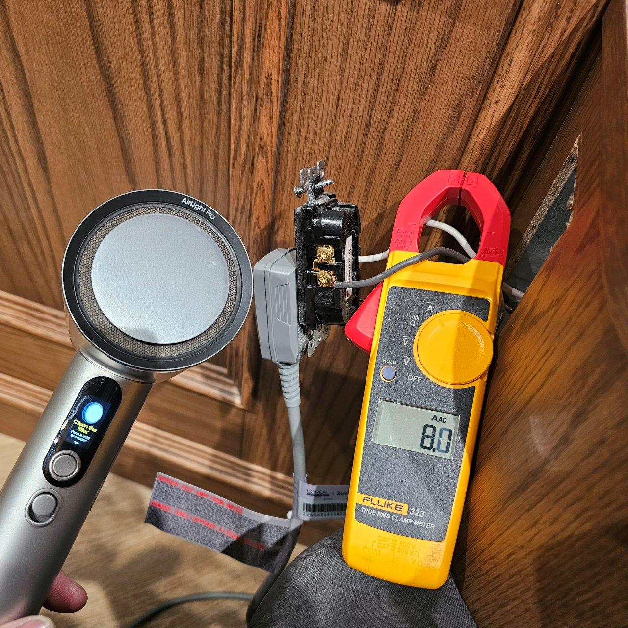 Fluke clamp meter measuring current during electrical troubleshooting