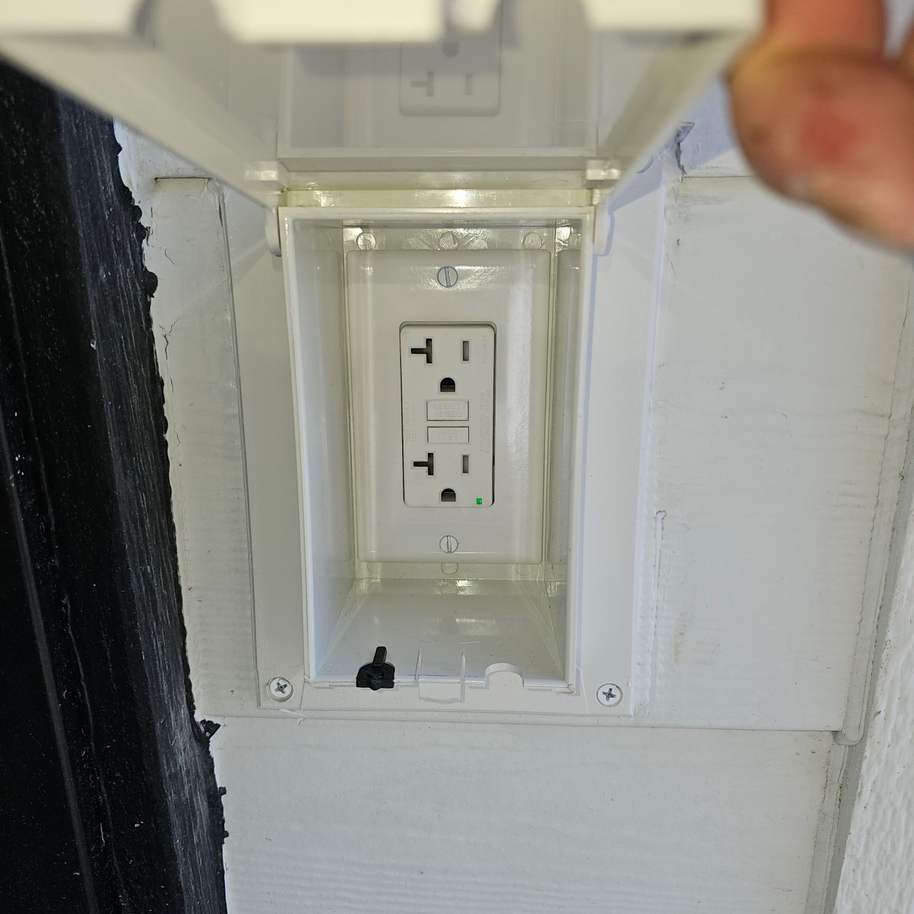 GFCI receptacle inside its outdoor enclosure with the cover open