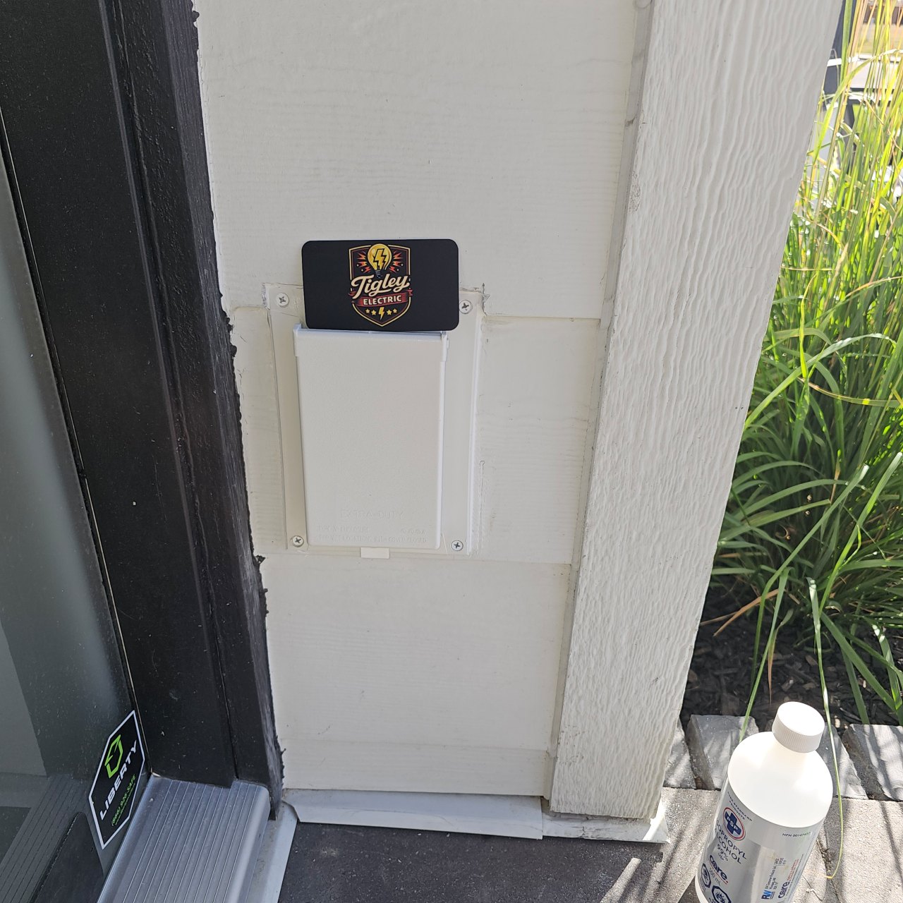 Outdoor receptacle with an enclosure designed for outdoor use and a Tigley business card