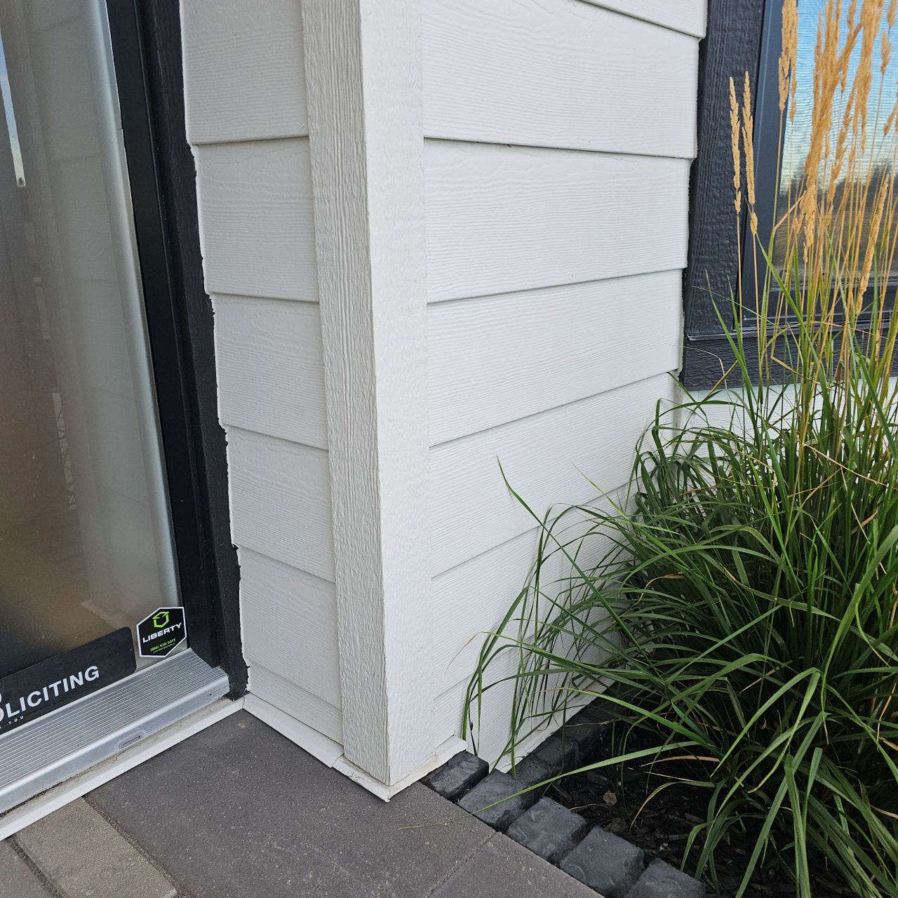 Exterior wall beside a patio door before an outdoor receptacle was added